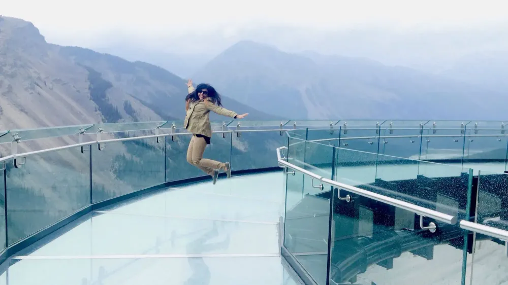 Woman jumping on the Jasper Skywalk